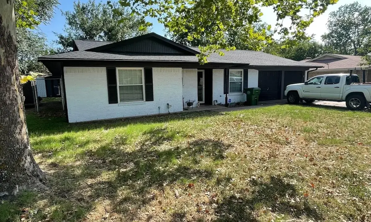 Professional roofing crew working on a residential roof in Timberwood Park